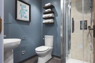 a bathroom with a toilet and a sink and a shower at Chainlocker in Falmouth