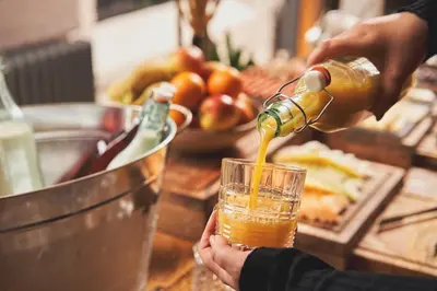 a person pouring a drink into a glass on a counter at Chainlocker in Falmouth
