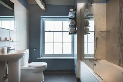 a bathroom with a sink and a toilet and a window at Chainlocker in Falmouth