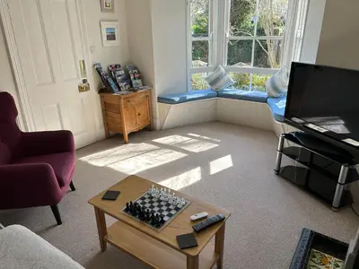 a living room with a coffee table and a tv at Brookdale House in Wadebridge