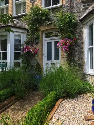 a stone house with flowers on the door at Brookdale House in Wadebridge