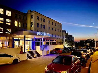 a parking lot with cars parked in front of a building at Pentire Newquay Cornwall Hotel in Newquay