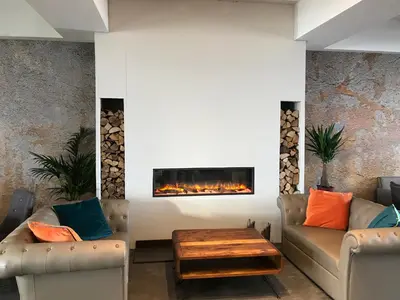 a living room with two couches and a fireplace at Pentire Newquay Cornwall Hotel in Newquay