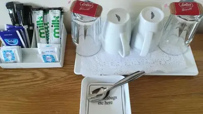 a table with a spoon and a container of toothbrushes at Pentire Newquay Cornwall Hotel in Newquay