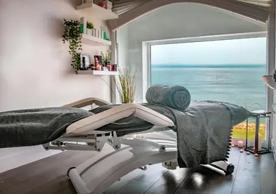 a massage room with a view of the ocean at Atlantic Hotel Newquay in Newquay