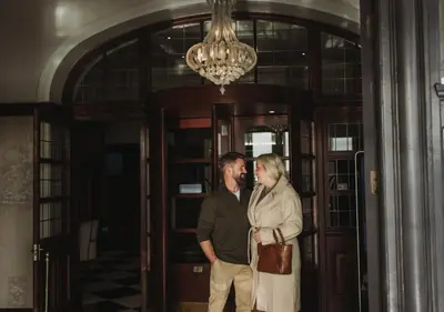 a man and a woman standing in front of a door at Atlantic Hotel Newquay in Newquay