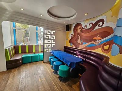 a waiting room with a pool table and a slide at Reef Lodge in Newquay