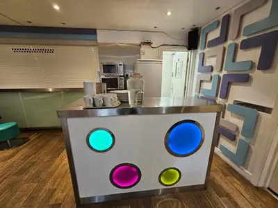 a kitchen with a counter with colorful eyes on it at Reef Lodge in Newquay
