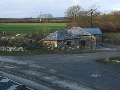 an old stone house on the side of a road at The Stable in Saint Clether