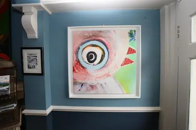 a painting of an eye on a blue wall at Bedlam House in Newquay