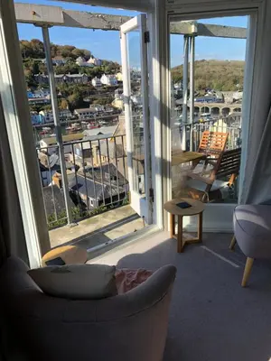 a living room with a couch and a large window at Penwyn Bed and Breakfast in Looe