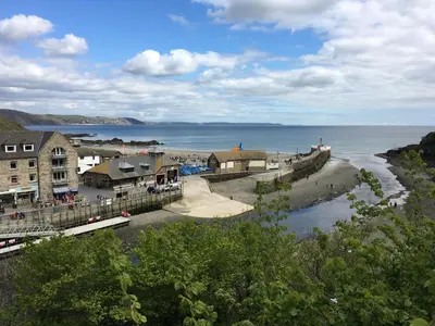 a view of a beach with buildings and the ocean at Penwyn Bed and Breakfast in Looe