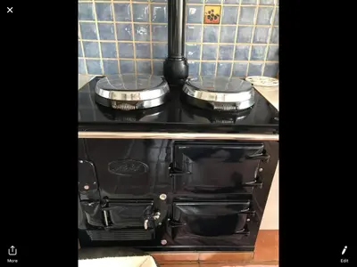 a stove with two pots and pans on top of it at Gwynarth Guest House in Wadebridge