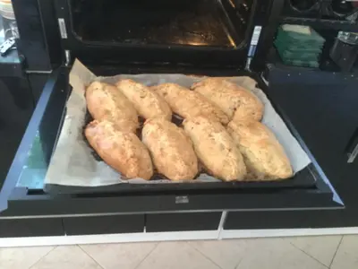 a group of breads are cooking in an oven at Gwynarth Guest House in Wadebridge