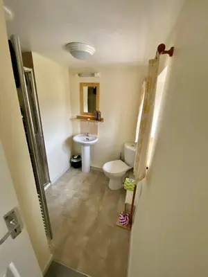 a bathroom with a toilet and a sink at Lynwood House Bed and Breakfast in Tregoney