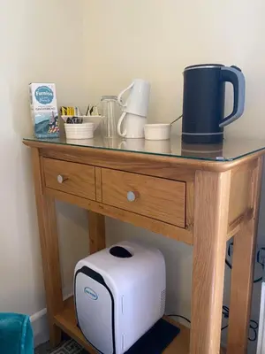 a table with a toaster and other items on it at Lynwood House Bed and Breakfast in Tregoney