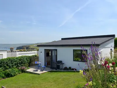 a small white house with a grass yard at Bosun's in Port Isaac