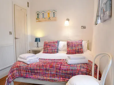 a bedroom with a bed with towels on it at Chapel Barn in Bodmin