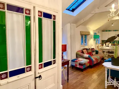 a living room with a couch and a table at Chapel Barn in Bodmin