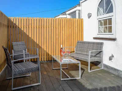 two chairs and a table on a patio at Towan View Loft in Newquay