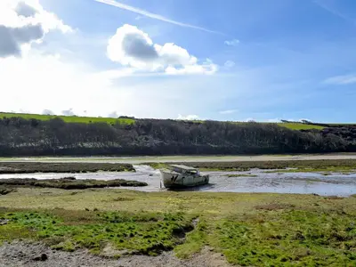 a boat sitting in the middle of a river at Towan View Loft in Newquay