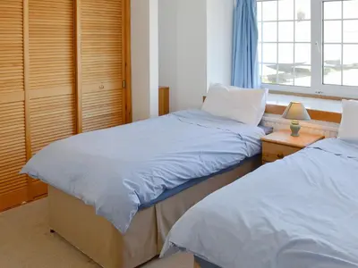 a bedroom with two beds and a window at Towan View Loft in Newquay