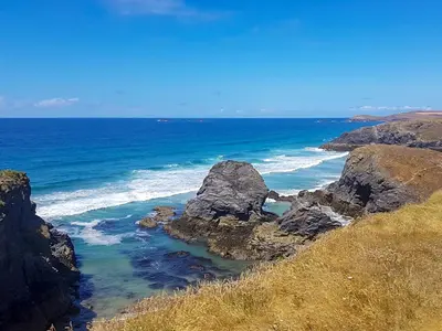 a view of the ocean with rocks in the water at Trevone in St Merryn