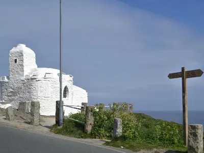an old church with a cross on the side of a road at Rosetta Apartments - Ocean Mist in Newquay