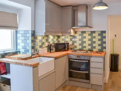 a kitchen with a sink and a stove at Rosetta Apartments - Ocean Mist in Newquay