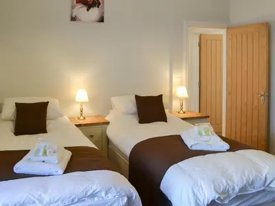 a room with two beds with towels on them at Rosetta Apartments - Ocean Mist in Newquay