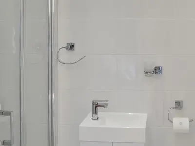 a bathroom with a shower and a sink at Rosetta Apartments - Ocean Mist in Newquay
