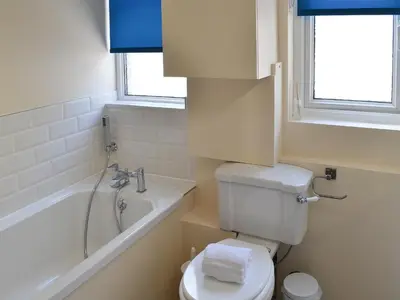 a bathroom with a toilet and a tub and a sink at Rosetta Apartments - Ocean Mist in Newquay