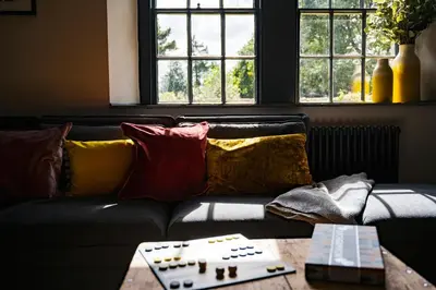 a living room with a couch with pillows and a table at Bogee Farm in Padstow