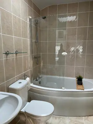 a bathroom with a tub and a toilet and a sink at Bogee Farm in Padstow