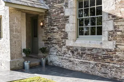 a brick house with a window and a door at Bogee Farm in Padstow