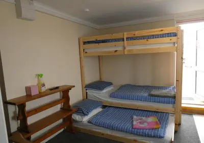 two bunk beds in a room with a window at Longbeach- Adults Only in Newquay