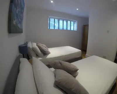 a room with two beds and a couch and a window at Rawley point in Newquay