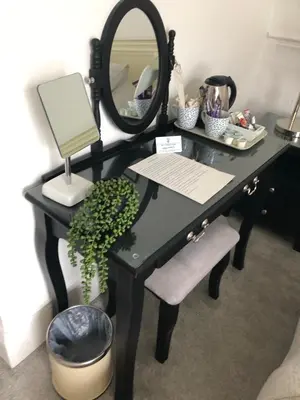 a black desk with a mirror and a mirror at Lazy Waves in Newquay