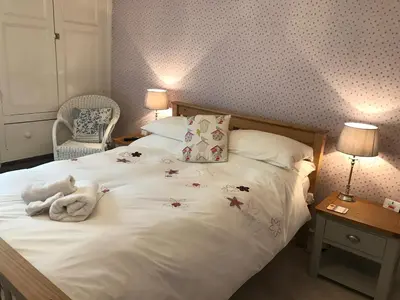 a bedroom with a bed with a stuffed animal on it at SPRING GARDENS B&B in Wadebridge