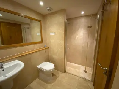 a bathroom with a shower and a toilet and a sink at OHANA HOUSE - Unbeatable Location - UK's Best Beaches in Newquay