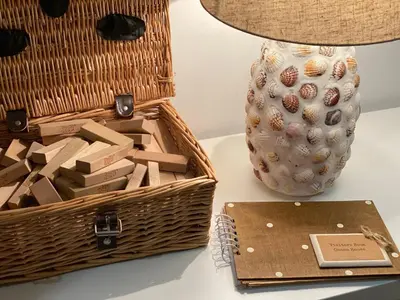 a table with a basket and a lamp and a vase at OHANA HOUSE - Unbeatable Location - UK's Best Beaches in Newquay
