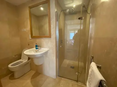 a bathroom with a shower and a toilet and a sink at OHANA HOUSE - Unbeatable Location - UK's Best Beaches in Newquay