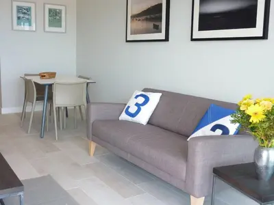 a living room with a couch and a table at Flat 8 Seascape in Newquay