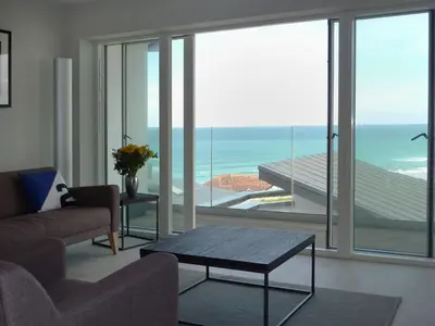 a living room with a view of the ocean at Flat 8 Seascape in Newquay