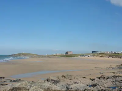 a beach with rocks and the ocean in the background at Flat 8 Seascape in Newquay