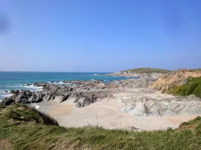 a beach with rocks and the ocean in the background at Flat 8 Seascape in Newquay