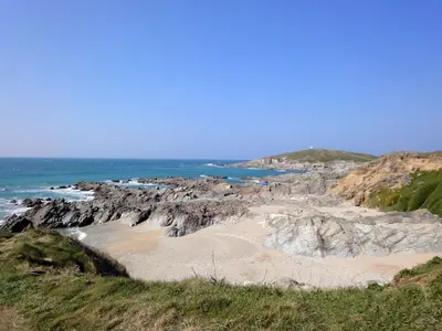 a beach with rocks and the ocean in the background at Rosen in Crantock