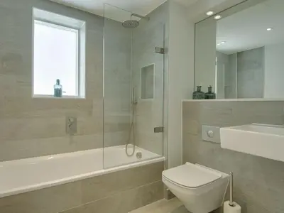 a bathroom with a shower and a toilet and a sink at Rosen in Crantock