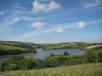 a river in a field with boats in it at Blue Seas in Saint Mawes