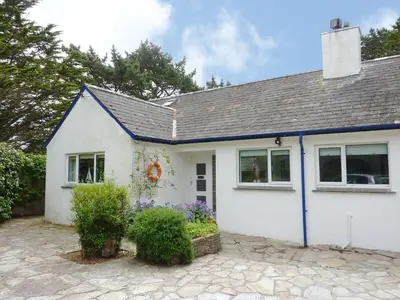 a white house with a blue roof at Blue Seas in Saint Mawes